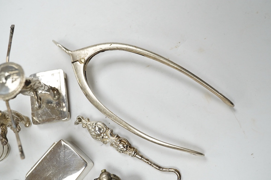 Sundry small silver including a vesta case, two wine labels, mounted glass scent bottle, wishbone sugar nips, sovereign case, etc. and a plated wine label. Condition - poor to fair to good
